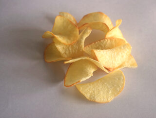 Reference-only industry photograph from Wikimedia Commons (cassava chips). Not an Azhar Food factory original.