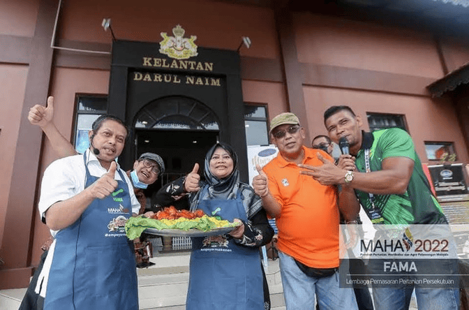 Business plan event or exhibition; MAHA/Kelantan background visible.