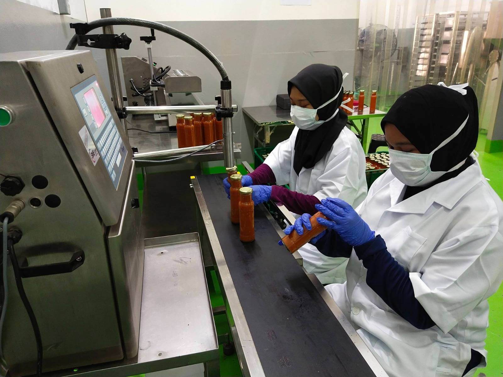 Staff checking bottled sauce